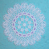 small lace doily with ribbon